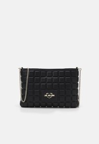 Black quilted handbag made of faux leather, featuring a gold logo plate and chain strap. Rectangular shape with textured squares.