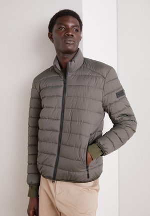 Gray puffer jacket with horizontal stitching, high collar, and zippered front. Features contrasting green cuffs and two side pockets.