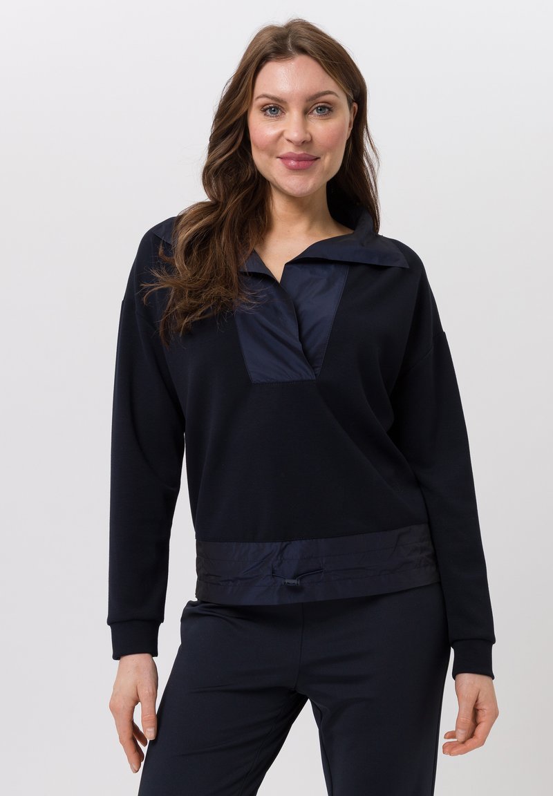 Marineblauwe pullover met een grote kraag, voorzien van een contrasterend satijnen paneel, lange mouwen en een elastische onderrand met een trekkoord.