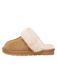 Tan suede slipper with a soft cream fur cuff, featuring a rubber sole, stitched detailing, and subtle brand logo on the side.