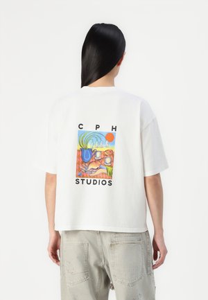 Hvid bomulds t-shirt med et farverigt grafisk motiv på ryggen med teksten "CPH STUDIOS" og et abstrakt design af en kande og kopper.