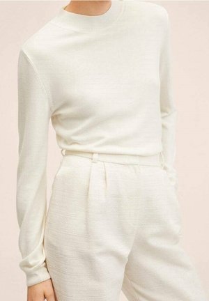 White knit long-sleeve top with a crew neckline, paired with light cream tapered trousers featuring pleats and textured fabric.