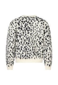 Maglione realizzato in morbido tessuto lavorato a maglia, con una base crema e pattern a macchie nere, colletto rotondo e polsini e orlo a coste.