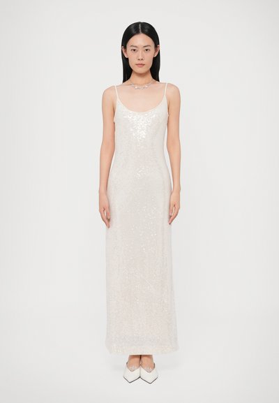 Sequin evening gown in light beige, fitted silhouette with spaghetti straps, featuring a smooth texture and a floor-length design.