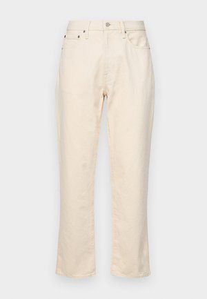 Beige színű pamut nadrág egyenes lábbal. Cipzáros derék, öt zseb, és diszkrét varrási részletek jellemzik. Texturált anyagfelület.