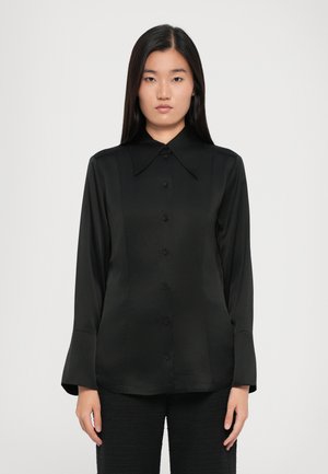 Black button-up shirt with a large collar, long sleeves, and a smooth, shiny fabric texture. Features matching black buttons and a tailored fit.