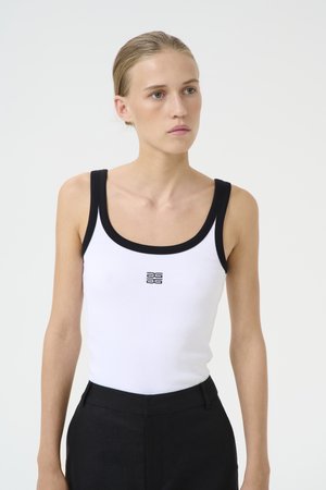 White ribbed tank top with black trim and logo at the center. The fabric has a soft texture, and it features a fitted silhouette.