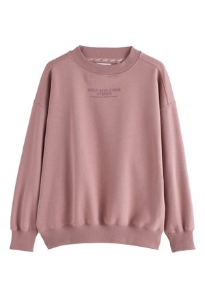 Mauve bluza z okrągłym dekoltem z prążkowanymi ściągaczami przy rękawach i u dołu, z napisem "SELF ATHLETICS STUDIO" umieszczonym na środku klatki piersiowej.