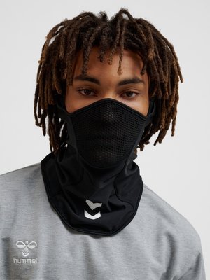Person with dreadlocks wearing a black ventilated face mask and neck gaiter, grey sweatshirt with a small white logo on the chest.