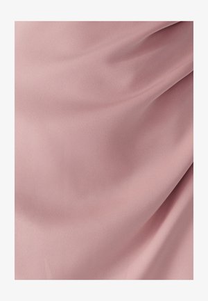 Soft pink fabric with smooth, gentle folds and a matte texture, highlighting the material’s softness and subtle draping.