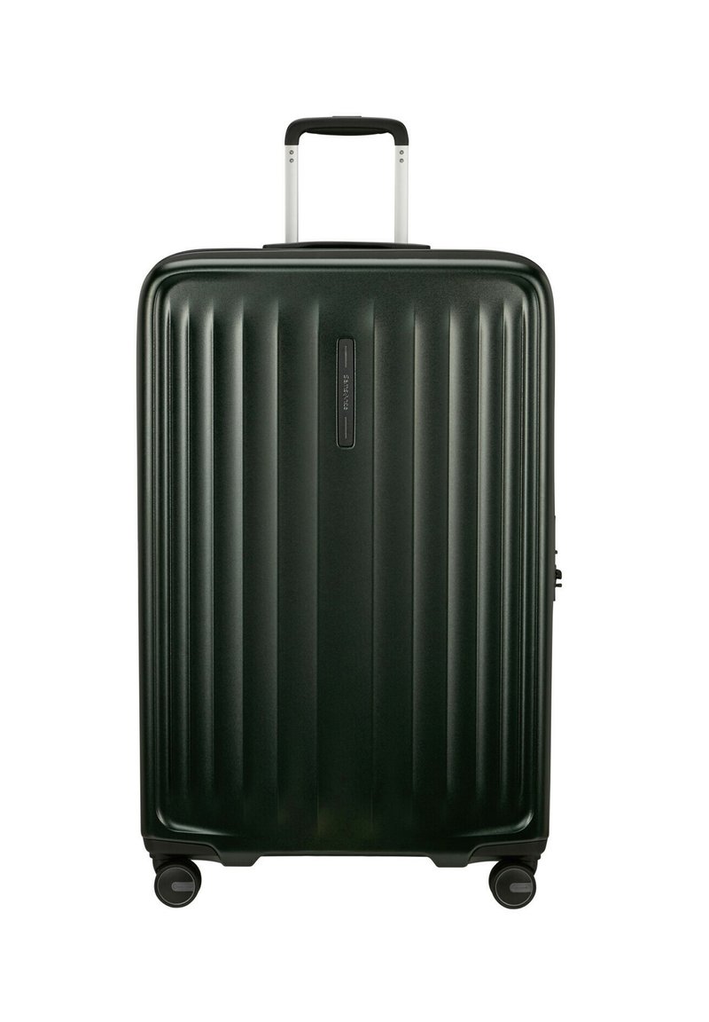 Hard-shell suitcase in dark green, featuring vertical ribbed texture, a telescopic handle, and four black wheels.