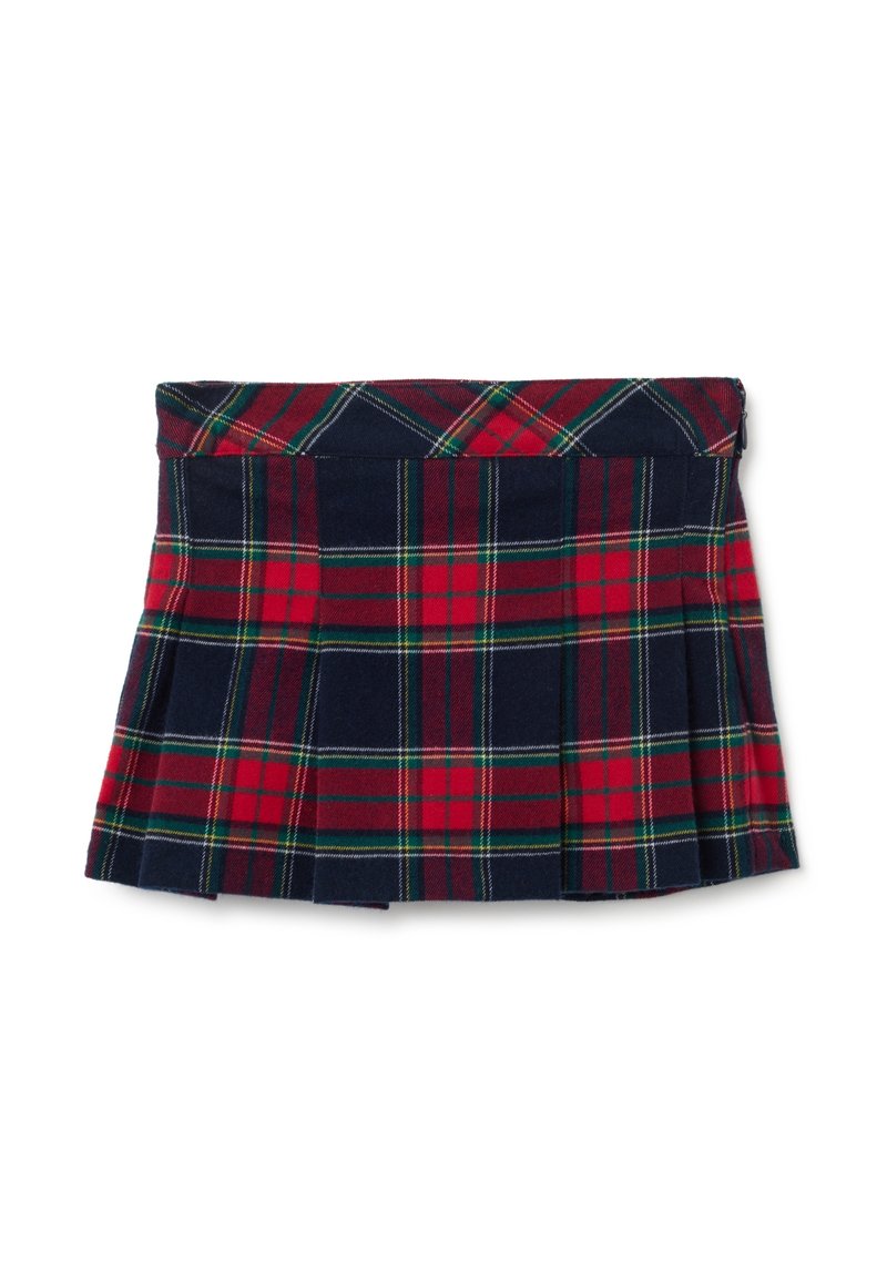 Gonna mini plissettata rossa e blu navy con motivo a quadretti verde, bianco e giallo, stesa su uno sfondo bianco.