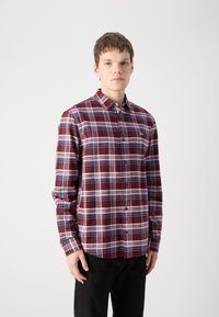 Camicia a quadri rossa e blu con collo, maniche lunghe e un piccolo logo sul petto. Tessuto di finitura liscia.