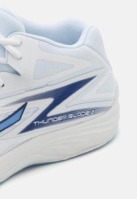 White athletic shoe with light blue mesh upper and blue accents. Features a curved sole and "THUNDERBLADEZ" branding in blue near the heel.