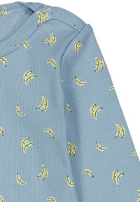 Modrý žebrovaný body s opakujícím se potiskem banánů v žluté barvě. Obsahuje patentky na rameni pro snadné oblékání.