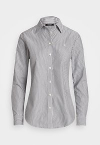 Raidallista nappikauluspaita pitkillä hihoilla, valmistettu puuvillasta. Ominaisuuksina kapeat mustat ja valkoiset raidat, klassinen kaulus ja helmiäisvalkoiset napit.