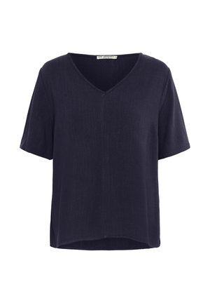 Navy blue short-sleeve V-neck blouse made from a smooth, lightweight fabric. Features a relaxed fit with a slightly longer back hem.