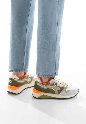 Sneakers with a mixed material design in white, olive green, and orange accents. Features a textured sole and angular star detailing.