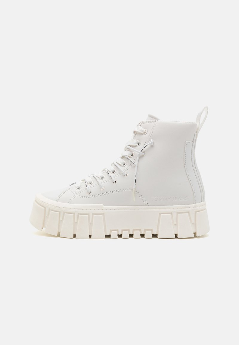Valkoiset korkeat tennarit paksulla kumipohjalla, valmistettu sileästä nahasta, jossa on metalliset silmukat ja Tommy Jeans -logo sivulla.