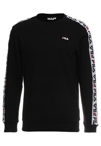 Sweat-shirt noir à col ras du cou, avec logo FILA blanc et rouge le long des manches. Confectionné en tissu doux, avec poignets et ourlet côtelés.