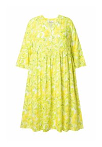 Sukienka w kwiatowy wzór w jasnym żółtym kolorze, wykonana z lekkiego materiału. Posiada luźny krój, rękawy do połowy przedramienia oraz marszczoną spódnicę.