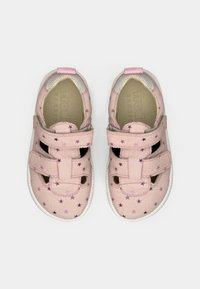 Ζευγάρι ροζ παπούτσια για μωρά με μοτίβα από μωβ αστέρια και δύο λουριά Velcro σε λευκό φόντο.