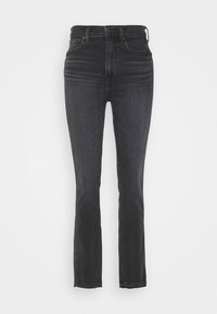 Jeans pretos de cintura alta com um design ajustado, ligeiramente em forma de bota e bainha desfeita. Feitos de denim com uma textura de peso médio.