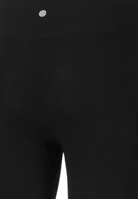 Schwarze Leggings aus dehnbarem Material, mit hohem Taillenbund und einem kleinen Logodetail auf der Rückseite. Glatte Textur, figurbetontes Design.