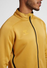 Hummel JACKET - Trainingsjacke - antique gold