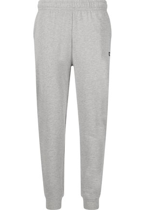 Lysegrå joggingbukser med elastisk talje og manchetter, sidelommer og en lille sort logo på højre lår.