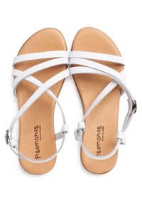 Sandali bianchi con cinturini, con suola piatta, caratterizzati da cinturini sottili e una soletta in pelle naturale. Superficie testurizzata sulla suola.