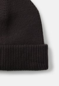 Black ribbed knit beanie with a folded cuff. Features a soft texture and smooth stitching. Suitable for casual wear in cold weather.
