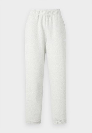 Pantalon de survêtement gris clair avec une taille élastique, des jambes fuselées et des poignets côtelés. Fabriqué à partir d'un tissu doux et texturé. Détail logo blanc sur le côté.