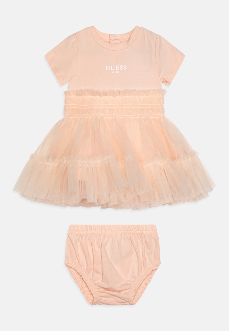 Vestido rosa de algodón con falda de tul, cintura fruncida y mangas cortas. Incluye cubrepañal rosa de algodón a juego. Logotipo de texto en el pecho.