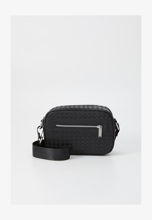 Black rectangular crossbody bag made of textured material, featuring a front zip pocket, a flat handle, and a detachable strap.
