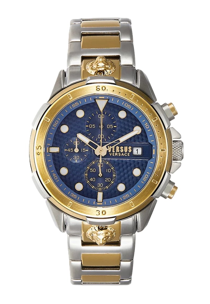 Montre à cadran bleu avec accents dorés, bracelet en acier inoxydable et en ton or, sous-cadrans et détail de tête de lion sur le côté. Fonction chronographe visible.