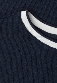 Close-up of a dark blue knitted sweater with a round neckline trimmed in white and dark blue ribbed fabric.