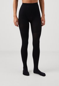 Černé legíny s vysokým pasem, vyrobené z hladkého, elastického materiálu. Disponují bezešvou konstrukcí a stylovými nohavicemi.