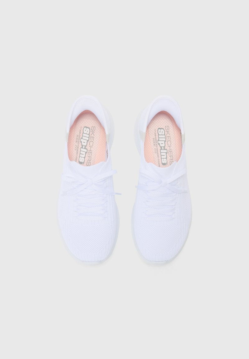 Sneakers bianchi slip-on con tomaia in maglia testurizzata, dotate di una soletta rosa chiaro e lacci bianchi. Design minimalista con punta arrotondata.