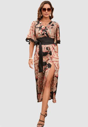 Vestido largo tipo envolvente con un estampado paisley en rojo, crema y negro, con mangas cortas, una abertura lateral y un cinturón negro en la cintura.