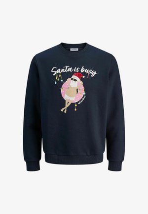 Sweatshirt bleu marine en coton, avec un graphique imprimé d'un Santa détendu portant des lunettes de soleil sur une bouée rose. Le texte indique "Santa est occupé."