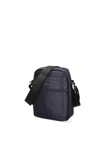 Borsa a tracolla in navy realizzata in tessuto resistente, con una tasca frontale con zip, tracolla regolabile e discreto logo sul fronte.