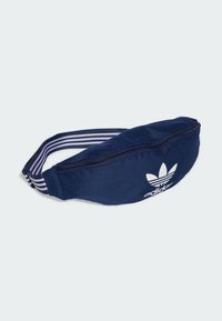 Navy blue fanny pack made of fabric with a smooth texture. Features a white Adidas logo and striped adjustable strap. Zipper closure.