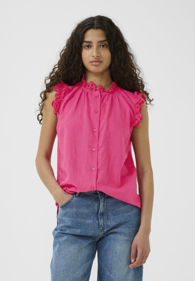 Blusa senza maniche di un vivace rosa con scollo arricciato e dettagli sulle spalle, dotata di chiusura con bottoni frontali e dettaglio di tessuto arricciato.