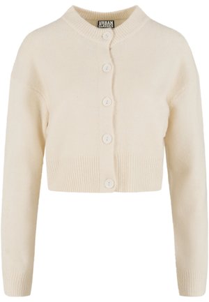 Keskipitkä kermavärinen neuletakki, valmistettu pehmeästä, teksturoidusta kankaasta, jossa on resorireunus ja viisi suurta nappia sulkemista varten.