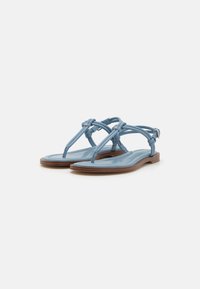 Sandale plate albastre cu un design cu curea împletită, material din piele netedă și talpă de culoare maro. Stil minimalist cu o cataramă ajustabilă.