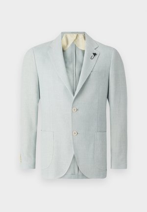 Light blue linen blazer with two front pockets, two buttons, and a contrasting cream-colored lining. Features a decorative pin on the lapel.