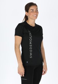 Black short-sleeve athletic shirt featuring a vertical "SWEDEMOUNT" logo in silver. Made of lightweight material with a fitted design.