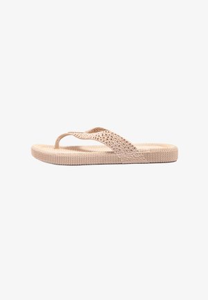 Light beige flip-flop sandal with a textured sole, decorative cutouts on straps, and a flexible design suitable for casual wear.
