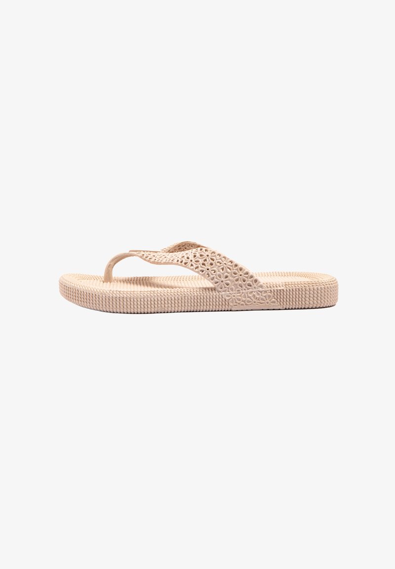 Light beige flip-flop sandal with a textured sole, decorative cutouts on straps, and a flexible design suitable for casual wear.